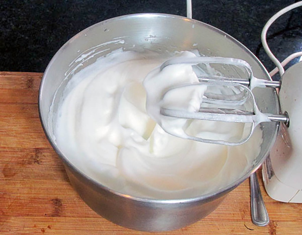 Whisk until the whites are fluffy and form stiff peaks.