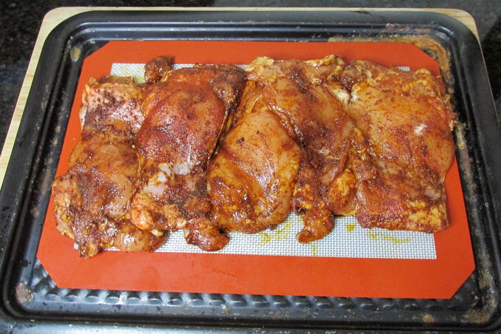 Place the chicken on the lined baking tray.